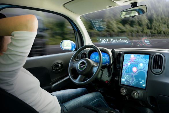 Interior of a vehicle with digital displays indicating self-driving mode